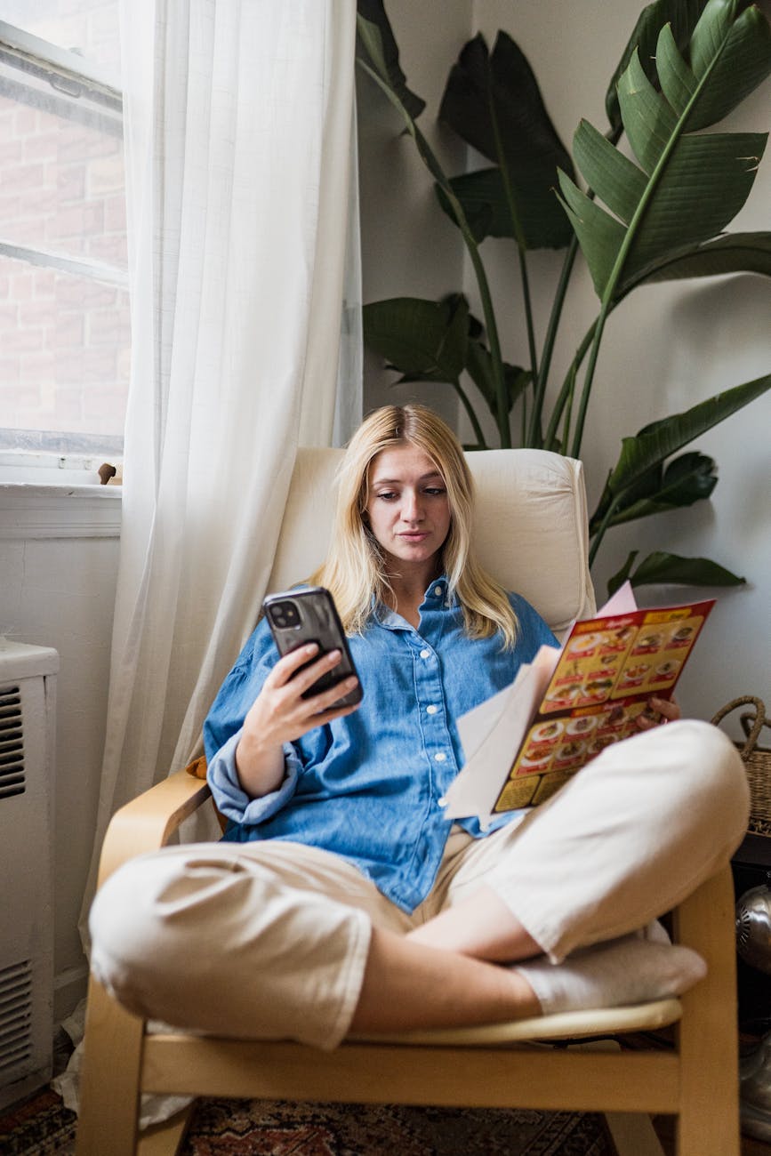 woman sitting in armchair and reviewing how to ask questions on a menu